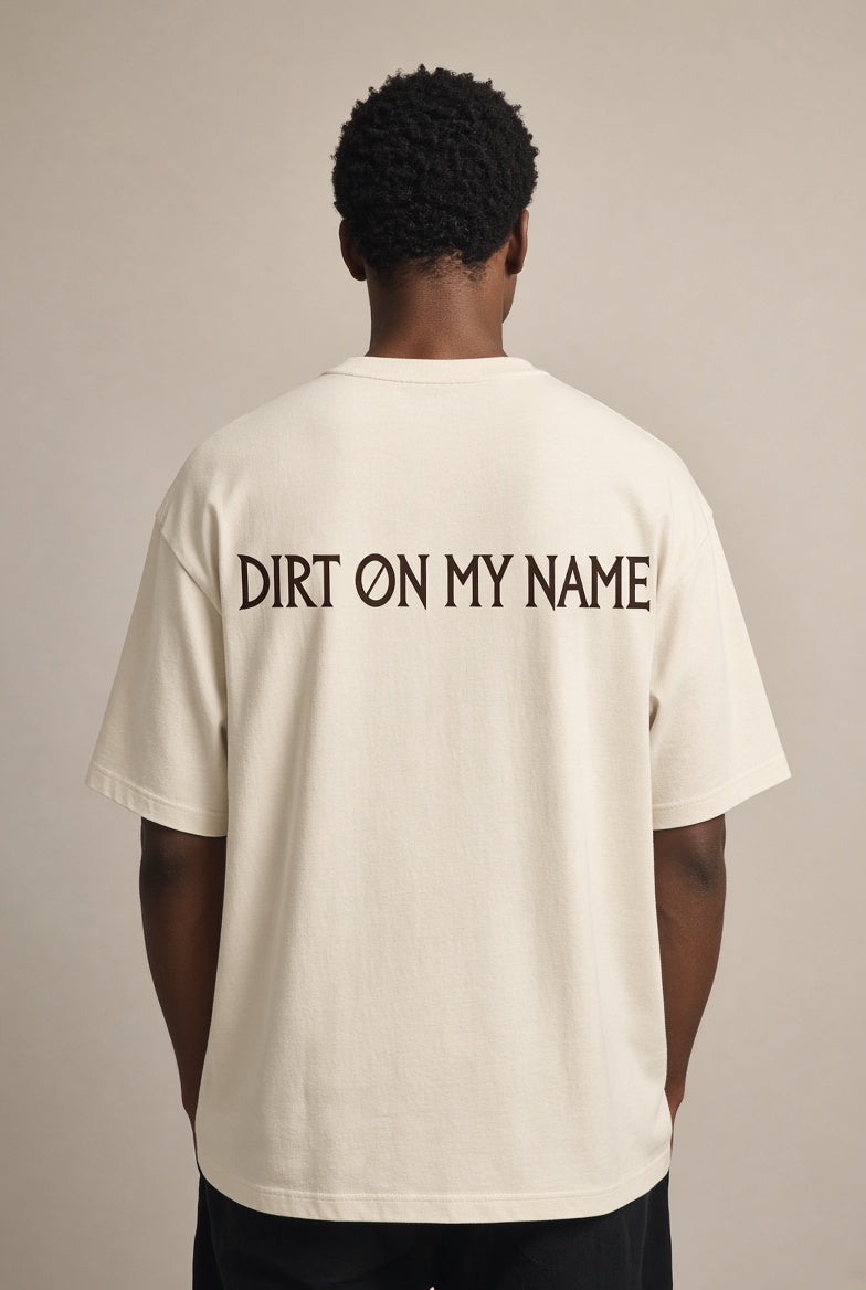 Model wearing the DOMN Dirt On My Name heavyweight T-shirt in Warm Bone, back view