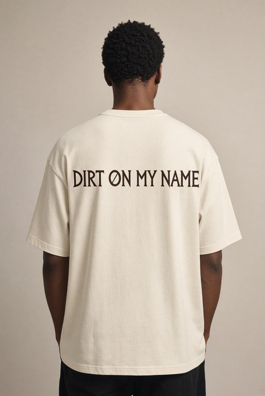 Model wearing the DOMN Dirt On My Name heavyweight T-shirt in Warm Bone, back view