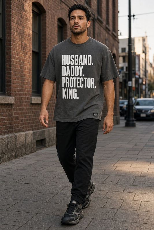 Model wearing the DOMN Husband Daddy Protector King heavyweight T-shirt in Graphite, front view